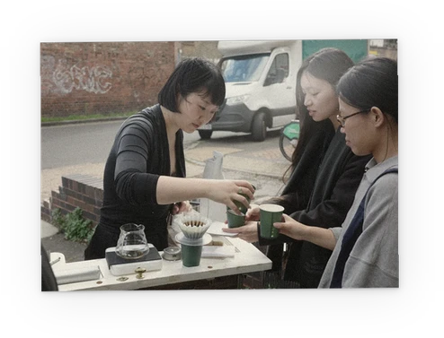Handing out cups of coffee